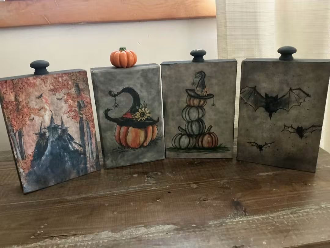 Four Halloween decorative panels featuring a castle, pumpkins, a witch hat, and bats