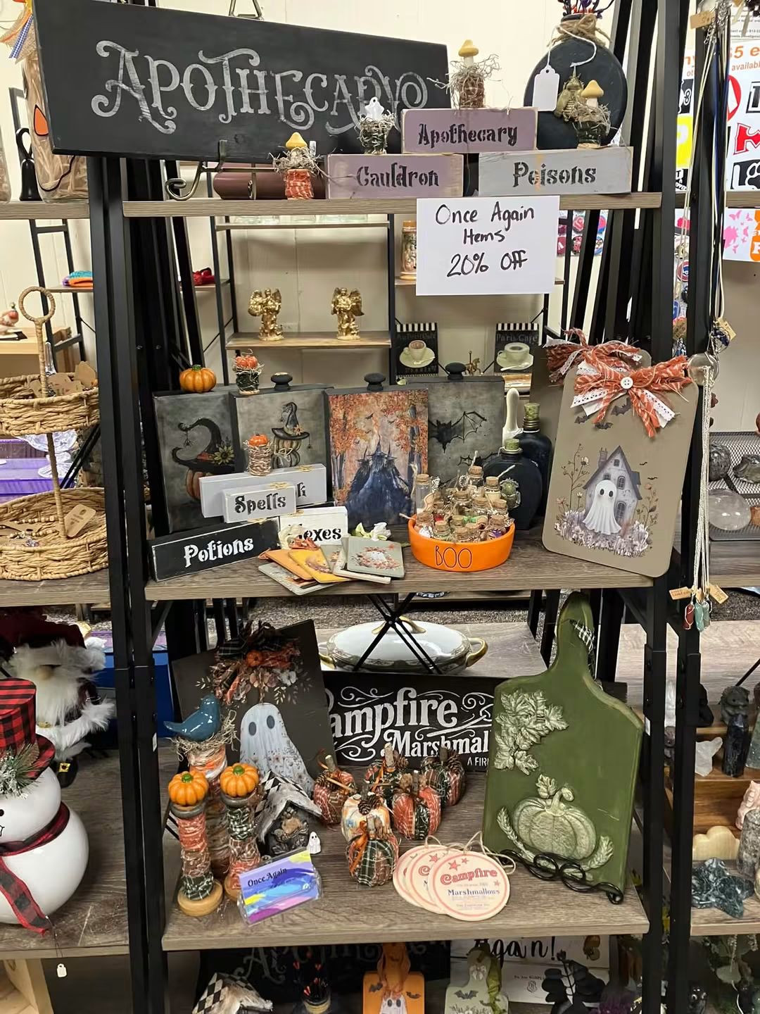 Once Again in-store display with seasonal signs, decorative bottles, pumpkin accents, and ghost-themed pieces