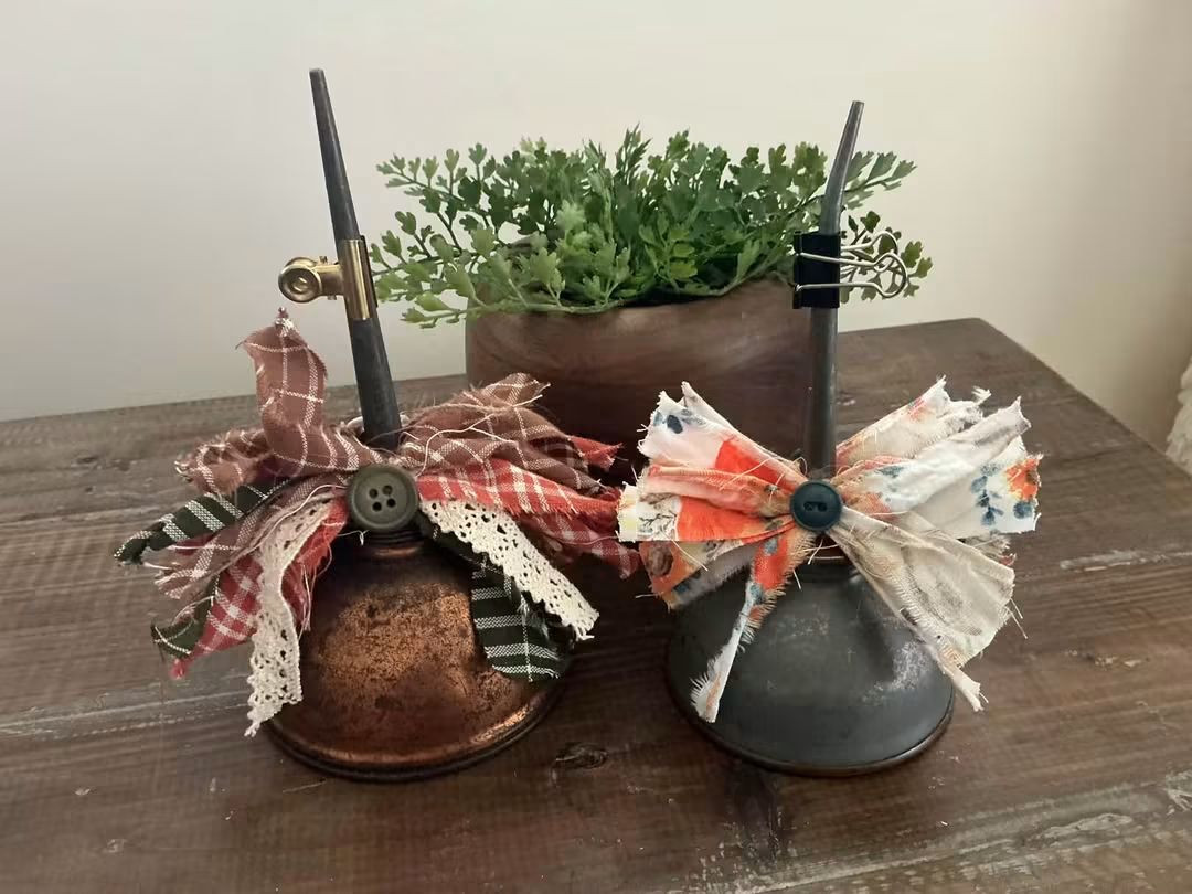 Two cone-shaped tabletop decorations with colorful ribbon bows beside a planter